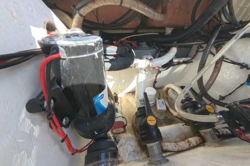 Slide: The Image of Engine compartment of a 2020 Velocity 262cc boat, featuring pumps and wiring. - 27