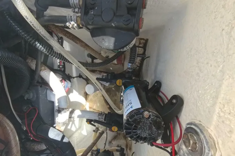 Slide: The Image of Engine compartment of a 2020 Velocity 262cc boat, showcasing hoses and mechanical components. - 28