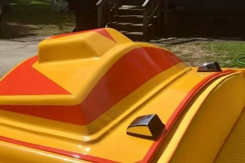 Slide: The Image of Yellow and red Sleekcraft Kuaui boat, 2009 model, with sleek design details. - 10