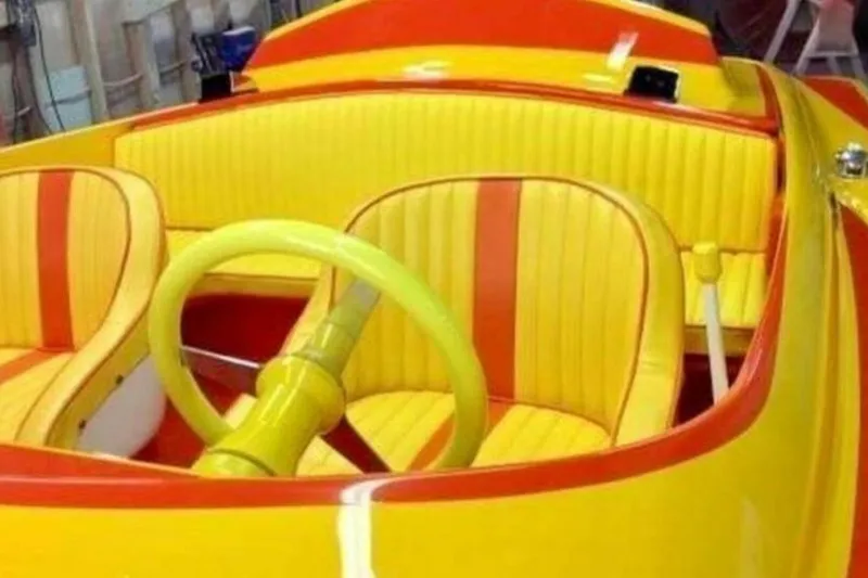Slide: The Image of Vibrant yellow and orange interior of 2009 Sleekcraft Kuaui boat. - 12