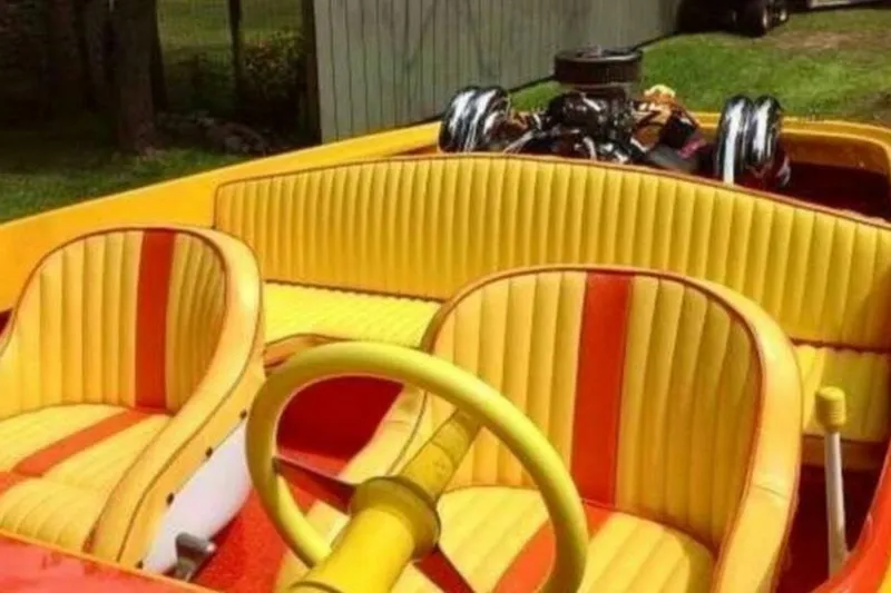 Slide: The Image of 2009 Sleekcraft Kuaui boat interior with vibrant yellow and orange seats. - 13