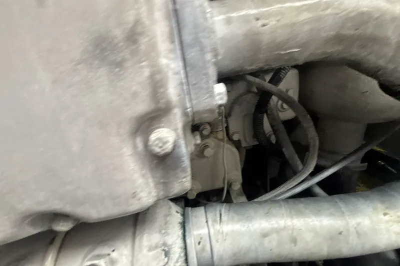 Slide: The Image of Close-up of 2009 Sleekcraft Kuaui engine components with visible hoses and bolts. - 16