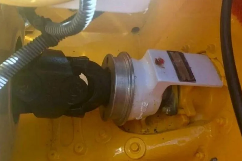 Slide: The Image of Close-up of 2009 Sleekcraft Kuaui boat engine component, featuring a yellow and black mechanical part. - 17