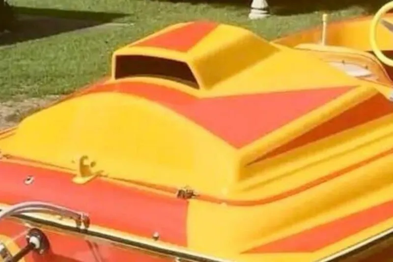 Slide: The Image of Bright yellow and red 2009 Sleekcraft Kuaui boat on grass. - 8