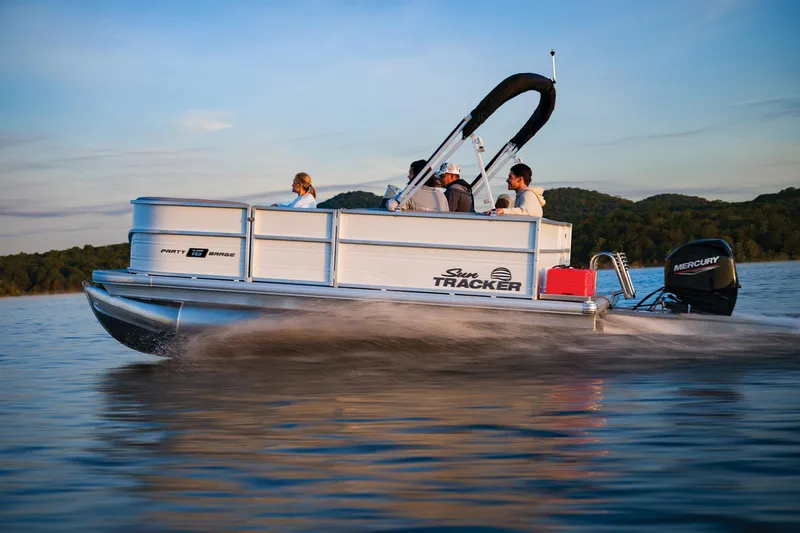 Slide: The Image of 2026 Sun Tracker Party Barge 16 DLX interior with gray seating and steering console. - 4