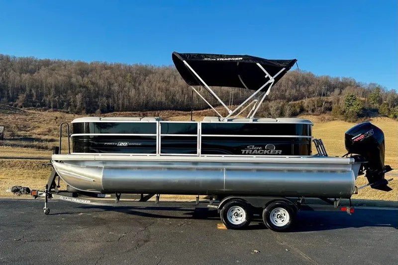 The Image of 2026 Sun Tracker Party Barge 20 DLX pontoon boat on trailer, scenic background. - 0