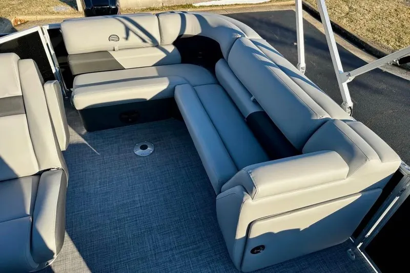 Slide: The Image of 2026 Sun Tracker Party Barge 20 DLX interior with plush gray seating and modern design. - 6