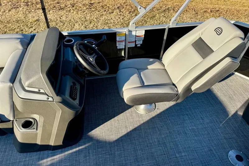 Slide: The Image of 2026 Sun Tracker Party Barge 20 DLX interior with steering console and captain's chair. - 7