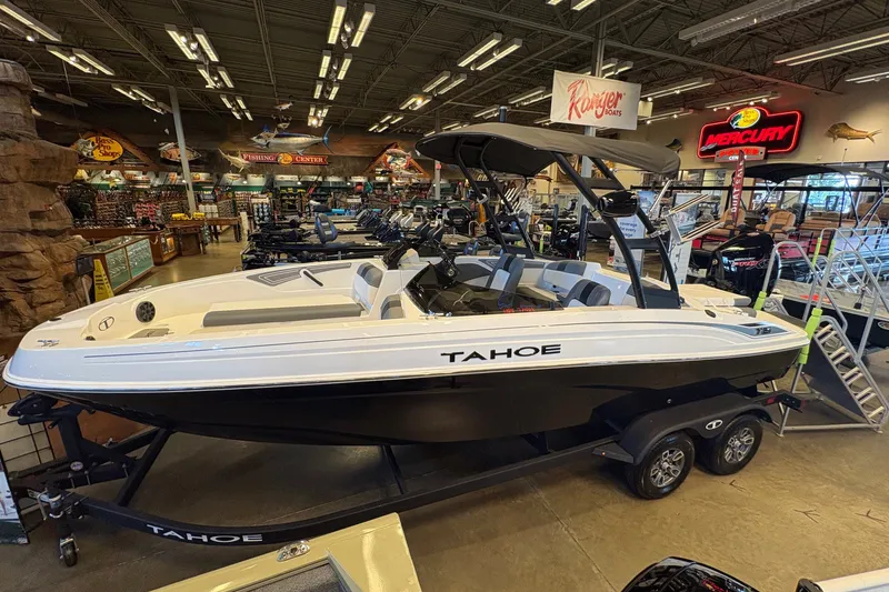 The Image of 2026 Tahoe T21 boat displayed indoors at a showroom, featuring sleek design and modern amenities. - 0
