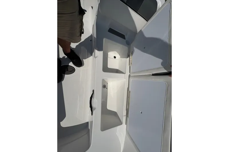 Slide: The Image of 2026 Tahoe T21 boat interior with open storage compartments and visible flooring. - 10