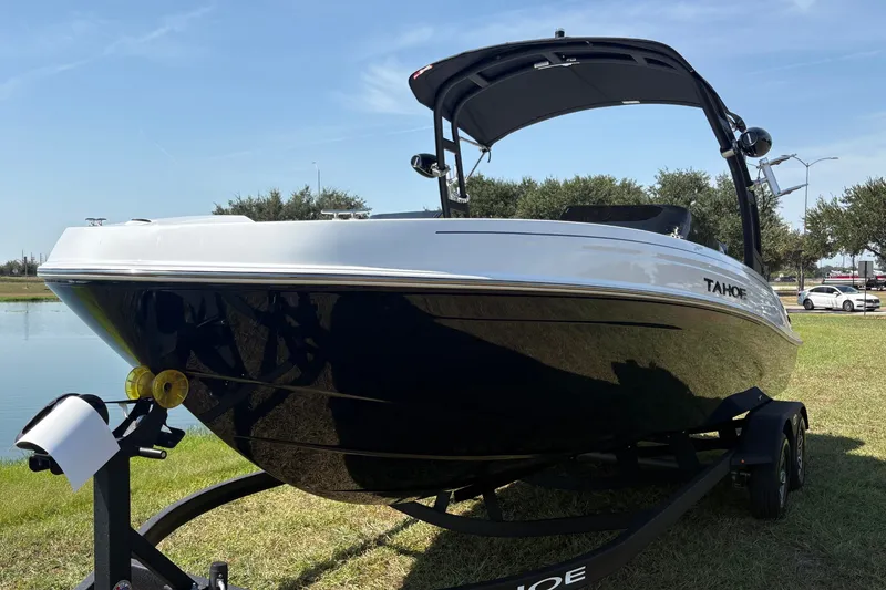 Slide: The Image of The image shows a 2026 Tahoe T21 boat on a trailer, ready for adventure. - 2