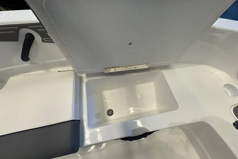 Slide: The Image of Interior view of 2026 Tahoe T21 boat, featuring storage compartment and seating area. - 14