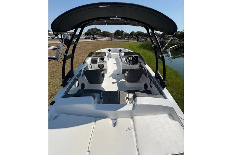 Slide: The Image of The image shows a modern boat with a black sunshade and multiple seating areas. - 7