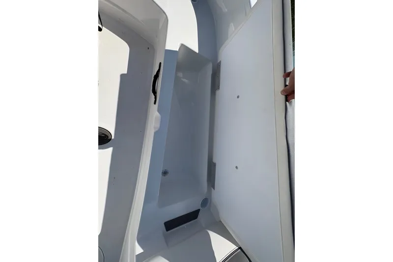 Slide: The Image of Open storage compartment in 2026 Tahoe T21 boat, showcasing spacious interior design. - 9