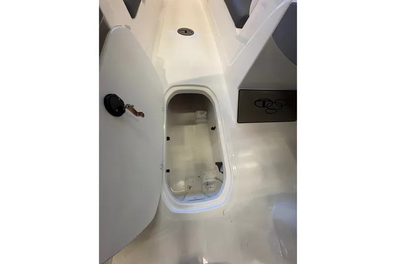 Slide: The Image of Open storage compartment in 2026 Tahoe T21 boat interior. - 16