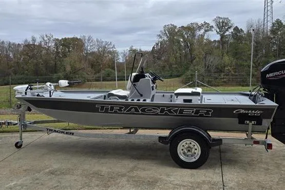 The Image of 2026 Tracker Bass Tracker Classic CC boat on trailer, parked outdoors. - 0
