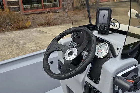 Slide: The Image of 2026 Tracker Bass Tracker Classic CC boat dashboard with steering wheel and navigation system. - 7