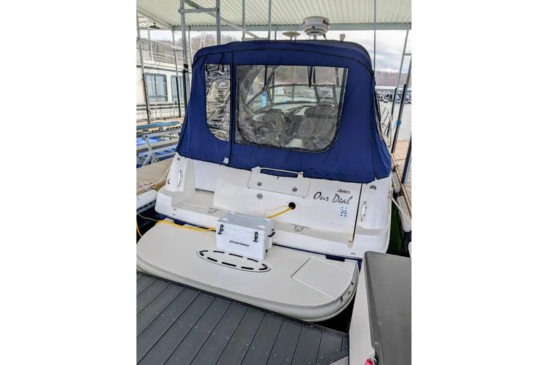 Slide: The Image of 2005 Sea Ray Sundancer 320 docked with blue canopy and swim platform. - 3