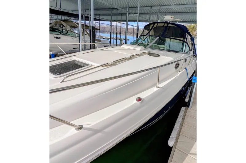 Slide: The Image of 2005 Sea Ray Sundancer 320 docked in a covered marina, side view. - 7