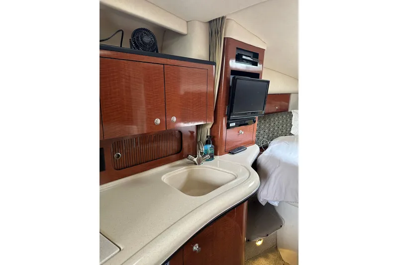 Slide: The Image of Interior of 2005 Sea Ray Sundancer 320 with kitchenette and TV setup. - 9