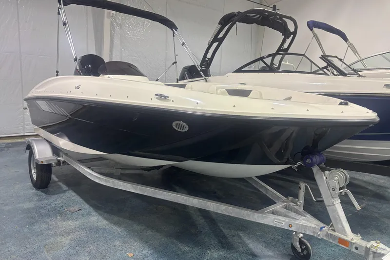 The Image of 2025 Bayliner Element E16 boat on trailer in showroom. - 0