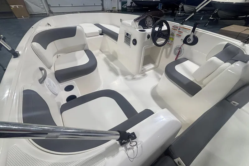Slide: The Image of 2025 Bayliner Element E16 boat interior with modern seating and steering console. - 9