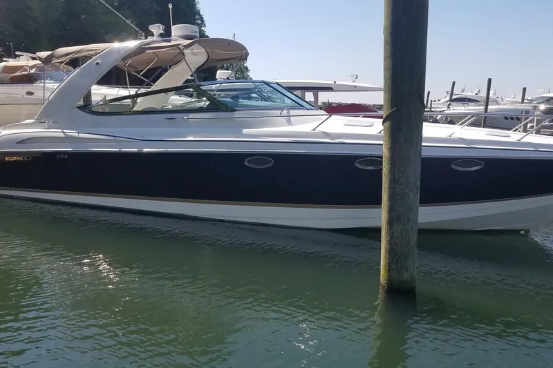 Slide: The Image of 2004 Formula 370 Super Sport boat docked in marina, side view. - 1