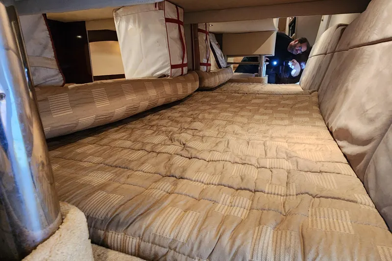 Slide: The Image of Interior cabin of 2004 Formula 370 Super Sport with beige bedding and storage. - 11