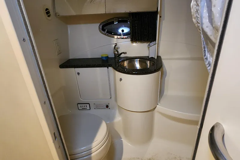 Slide: The Image of Compact bathroom in a 2004 Formula 370 Super Sport boat, featuring sink and toilet. - 12