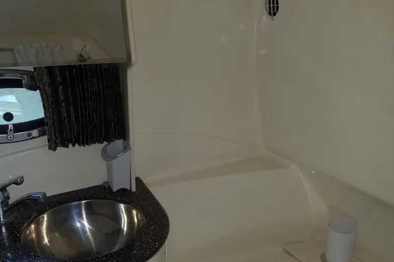 Slide: The Image of 2004 Formula 370 Super Sport boat bathroom with sink and window. - 14
