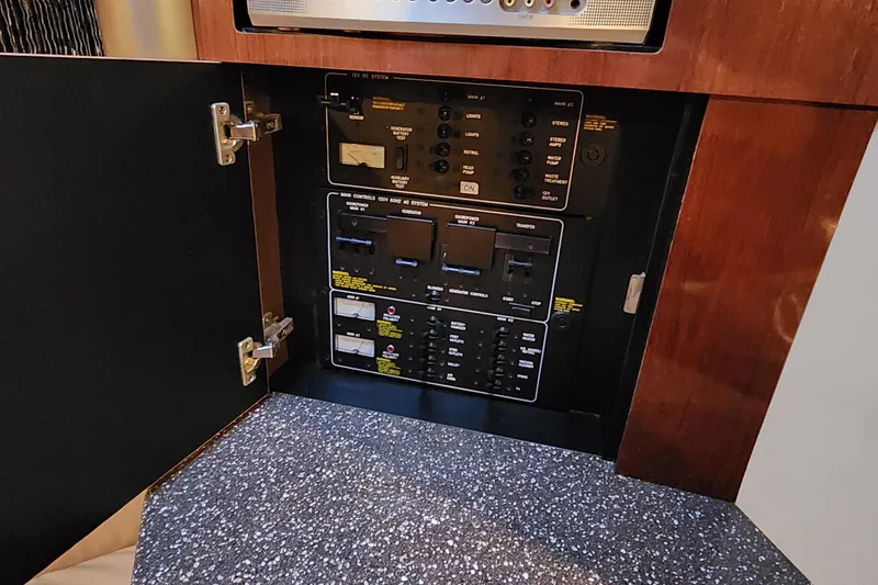 Slide: The Image of Electrical control panel inside 2004 Formula 370 Super Sport boat, featuring switches and circuit breakers. - 15