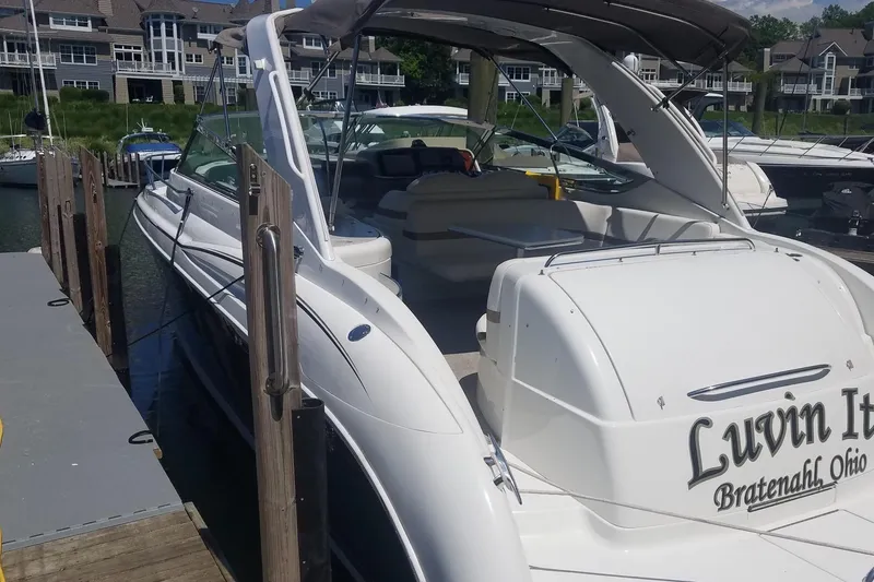 Slide: The Image of 2004 Formula 370 Super Sport boat docked, featuring spacious seating and sleek design. - 3