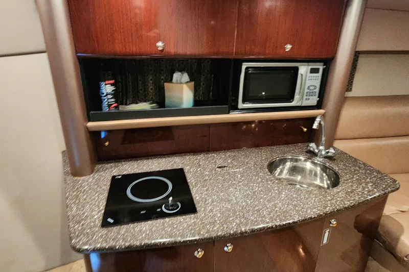 Slide: The Image of Interior of a 2004 Formula 370 Super Sport yacht with kitchenette, sink, and microwave. - 9