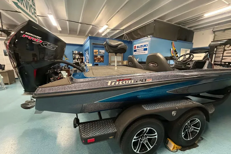 The Image of 2026 Triton 20XP boat in showroom, featuring Mercury Pro XS engine. - 0