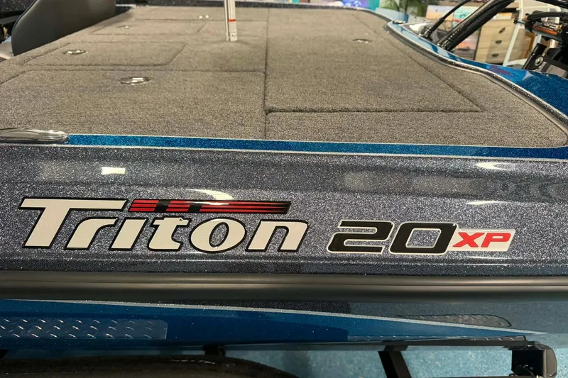 Slide: The Image of 2026 Triton 20XP boat with sleek design and metallic finish. - 1