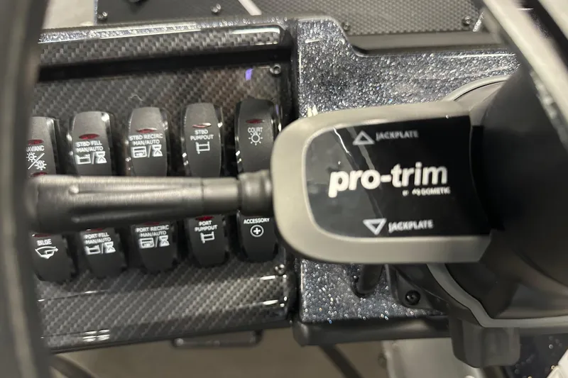 Slide: The Image of Control panel of 2026 Triton 20XP boat featuring pro-trim and various switches. - 13