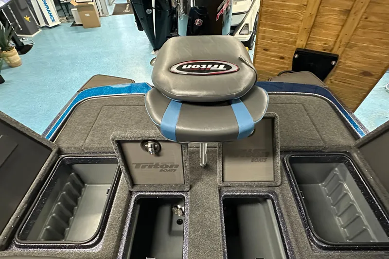 Slide: The Image of 2026 Triton 20XP boat interior with storage compartments and branded seat. - 16