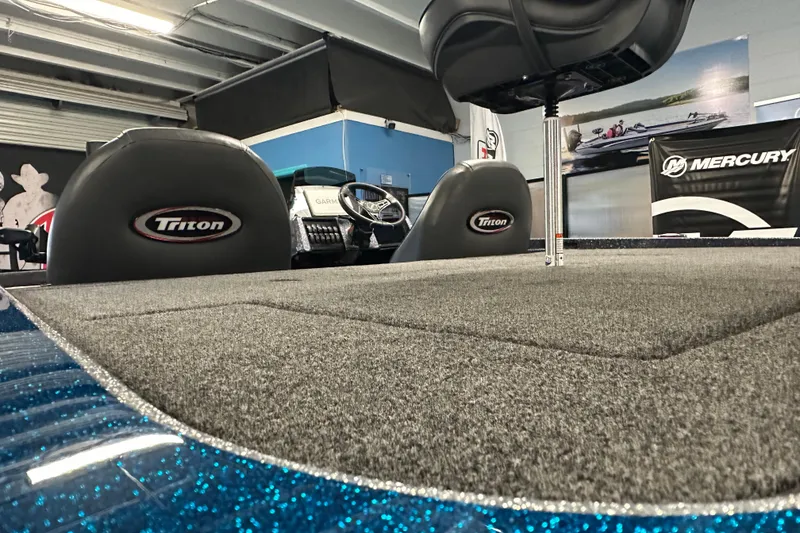 Slide: The Image of 2026 Triton 20XP boat interior with carpeted deck and branded seats. - 17