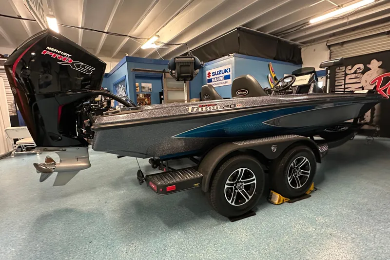Slide: The Image of 2026 Triton 20XP boat with Mercury Pro XS engine in showroom. - 20