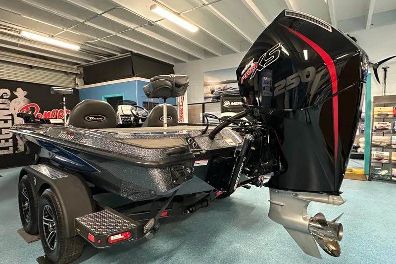 Slide: The Image of 2026 Triton 20XP boat with powerful 250 engine in showroom setting. - 23