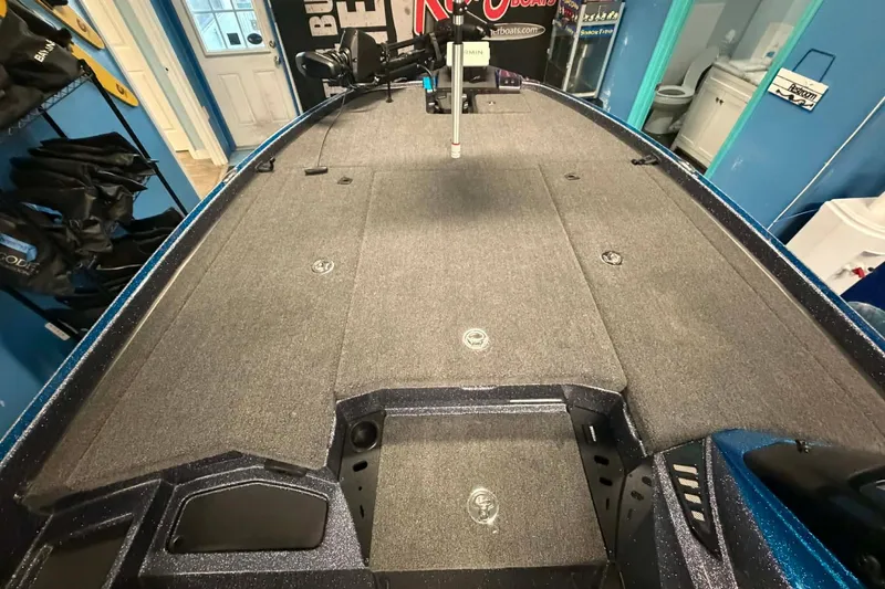 Slide: The Image of 2026 Triton 20XP boat deck with storage compartments and fishing equipment. - 3