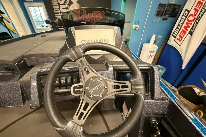 Slide: The Image of 2026 Triton 20XP boat dashboard with Garmin display and steering wheel. - 4