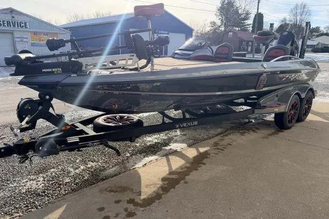 Slide: The Image of 2020 Vexus VX20 boat on trailer, parked outdoors, with visible equipment and accessories. - 11