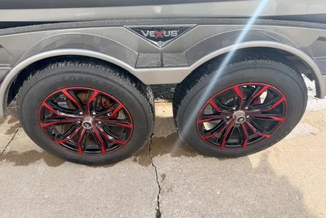 Slide: The Image of 2020 Vexus VX20 trailer wheels with red-accented rims on concrete surface. - 12