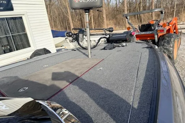 Slide: The Image of 2020 Vexus VX20 boat deck with equipment, parked near a building and orange tractor. - 6