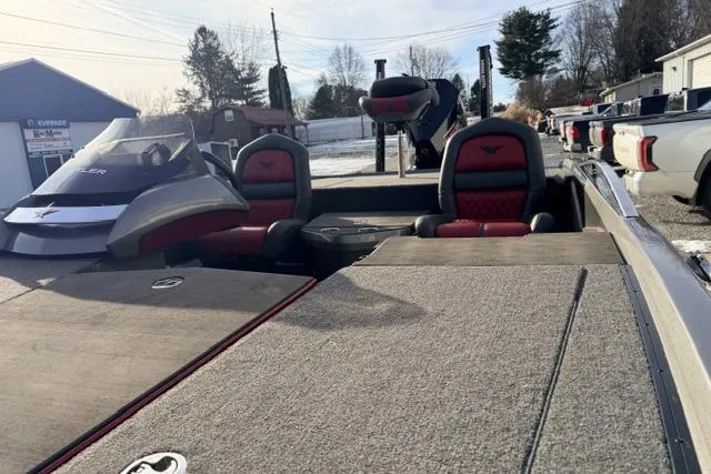 Slide: The Image of 2020 Vexus VX20 boat interior with red and black seats, parked outdoors. - 9