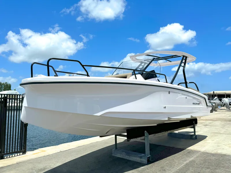 Slide: The Image of 2024 Axopar 25 Cross Top boat on display under a clear blue sky. - 4