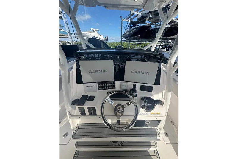 Slide: The Image of 2022 Sea Fox 328 Commander helm with dual Garmin displays and steering wheel. - 2