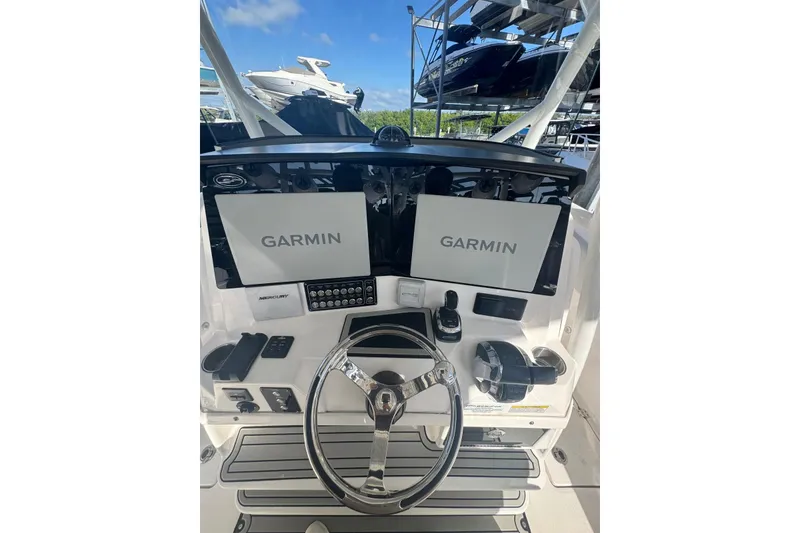 Slide: The Image of 2022 Sea Fox 328 Commander helm with dual Garmin displays and steering wheel. - 3