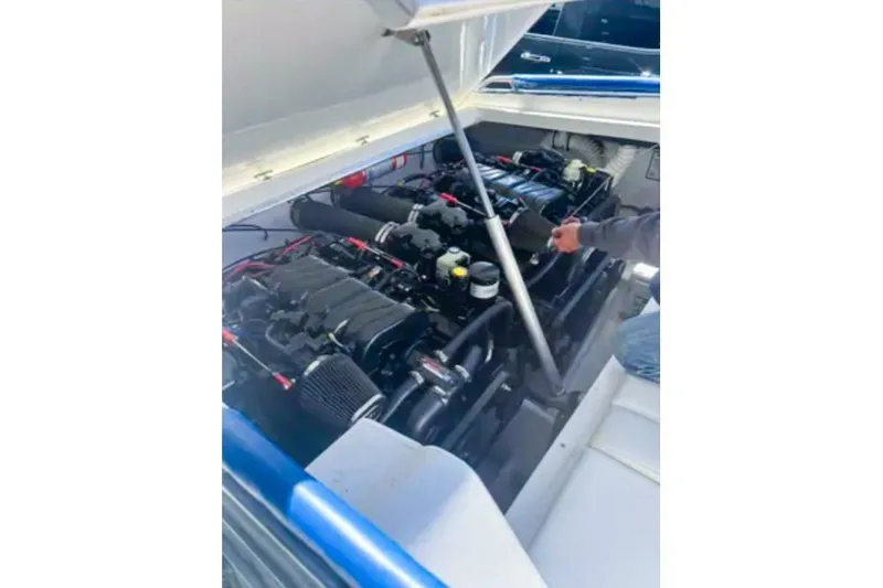 Slide: The Image of Engine compartment of a 2001 Sonic 31 SS boat with dual engines visible. - 13
